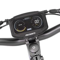 Digital display panel on Ausom F1 Max electric scooter handlebars showing speed, battery, and mode indicators.
